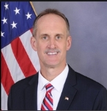 A person in a suit and tie

AI-generated content may be incorrect.