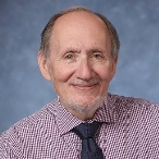 A person in a checkered shirt and tie

Description automatically generated