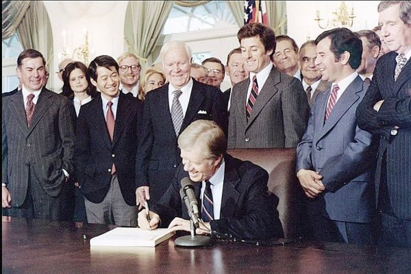 A group of people standing around a person signing a book

AI-generated content may be incorrect.