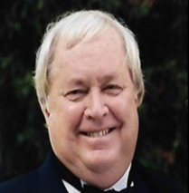 A person in a suit and bow tie

Description automatically generated