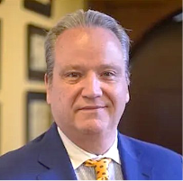 A person in a suit

Description automatically generated