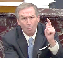 A person in a suit pointing his finger

Description automatically generated