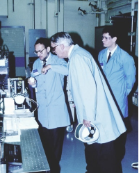 A group of men in lab coats

Description automatically generated