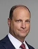 A person in a suit and tie

AI-generated content may be incorrect.