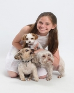 A child with two dogs

Description automatically generated