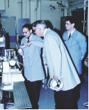 A group of men in lab coats

Description automatically generated