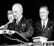 A group of men standing at a podium

Description automatically generated