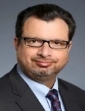 A person in a suit and tie

Description automatically generated