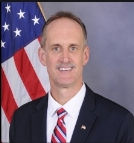 A person in a suit and tie

Description automatically generated