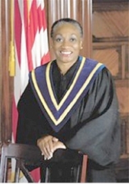 A person in a black robe

Description automatically generated