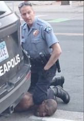 A police officer kneeling on the ground

Description automatically generated