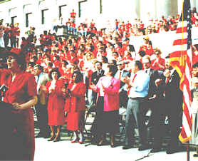 A group of people holding flags

Description automatically generated with medium confidence