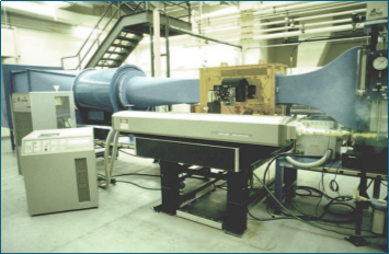 A large blue tube in a factory

Description automatically generated