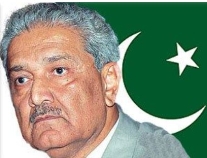 A person with a mustache and a green and white flag

Description automatically generated