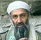 A person with a beard holding a microphone

Description automatically generated