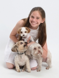 A child with two dogs

Description automatically generated