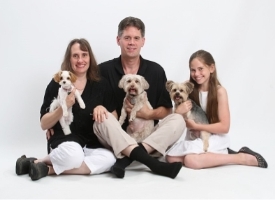 A family with dogs and a dog

Description automatically generated