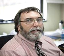 A person in glasses and a tie

Description automatically generated