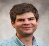 A person smiling for the camera

Description automatically generated